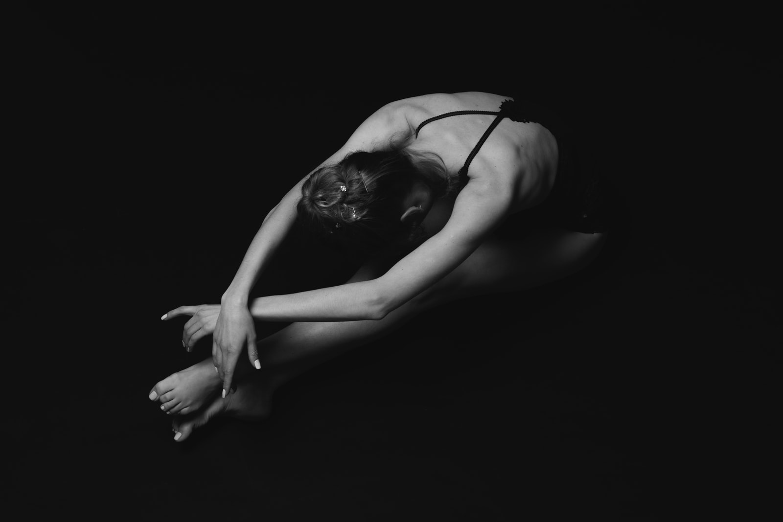 grayscale photography of unknown person stretching